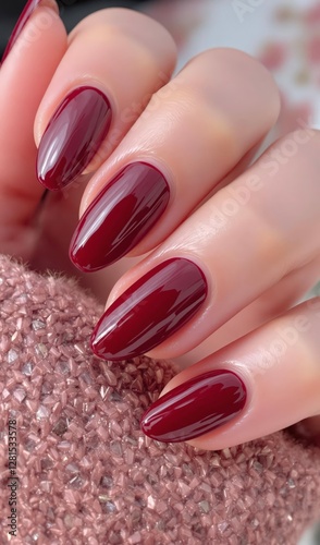 Beautiful woman’s nails in burgundy color