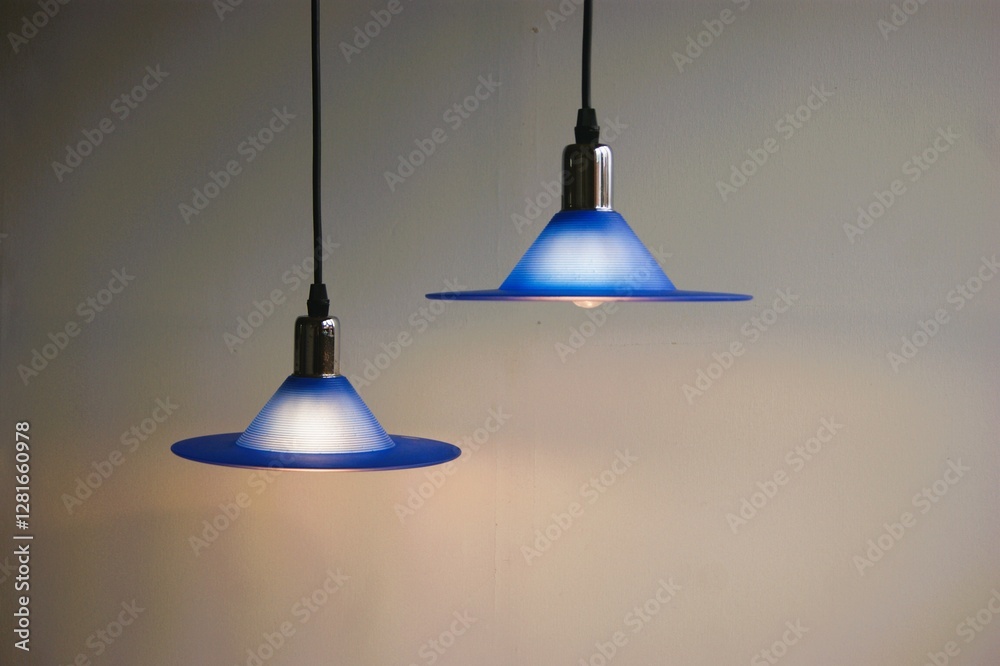 Obraz premium Hanging blue UFO shaped glass lamps. 