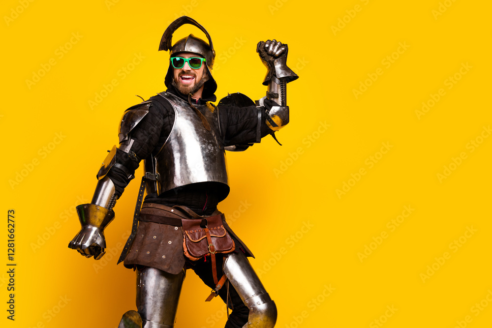 Armored man mixing medieval and modern styles with bright sunglasses on a vivid yellow background. Armored man mixing medieval and modern styles with bright sunglasses on a vivid yellow background.