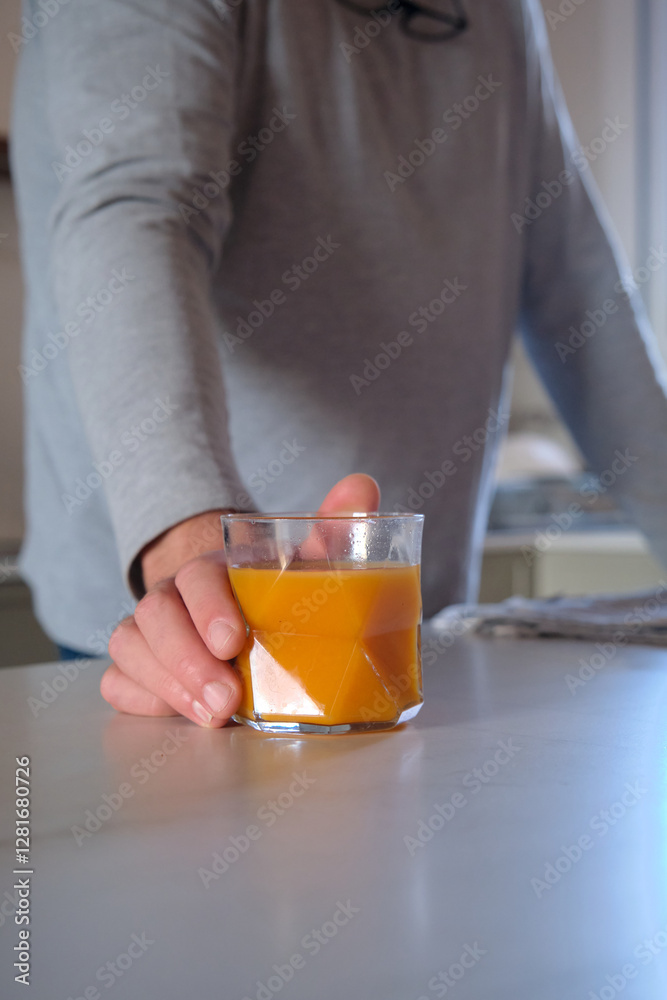 A glass of orange juice on the table A glass of orange juice on the table
