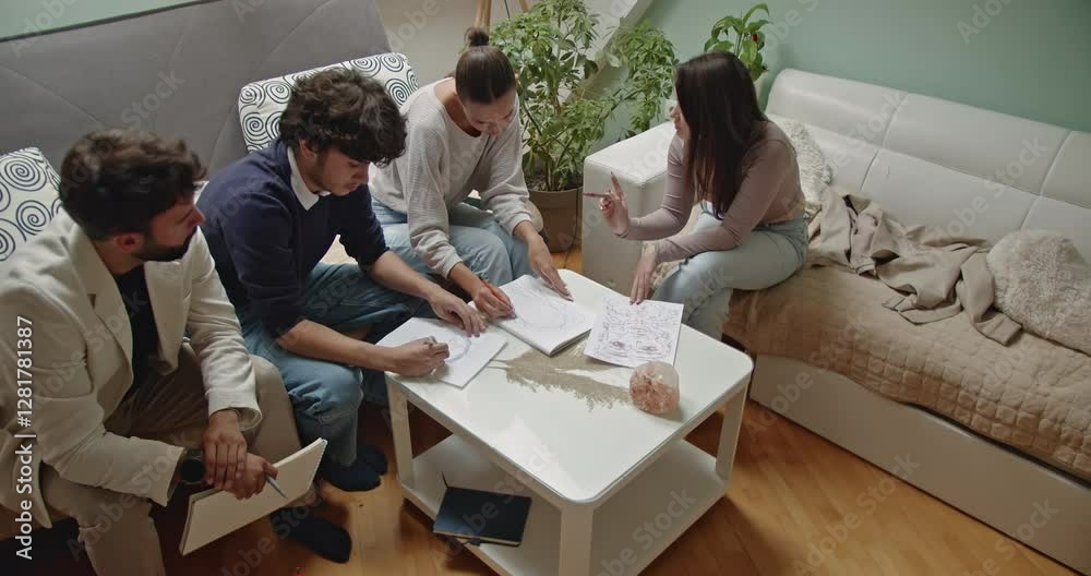 Students attending private art class at their professor's cozy home. They are drawing and learning together.