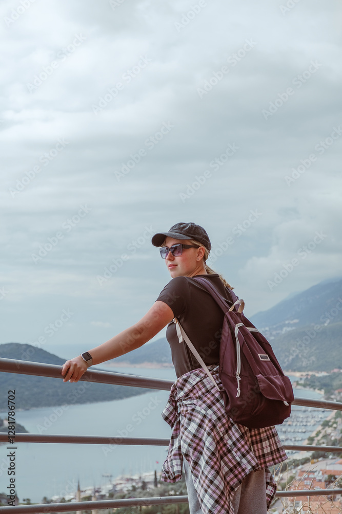 Young woman embracing the freedom of solo travel and digital nomad lifestyle while enjoying a scenic mountain view. A symbol of adventure, independence, and modern exploration Young woman embracing the freedom of solo travel and digital nomad lifestyle while enjoying a scenic mountain view. A symbol of adventure, independence, and modern exploration