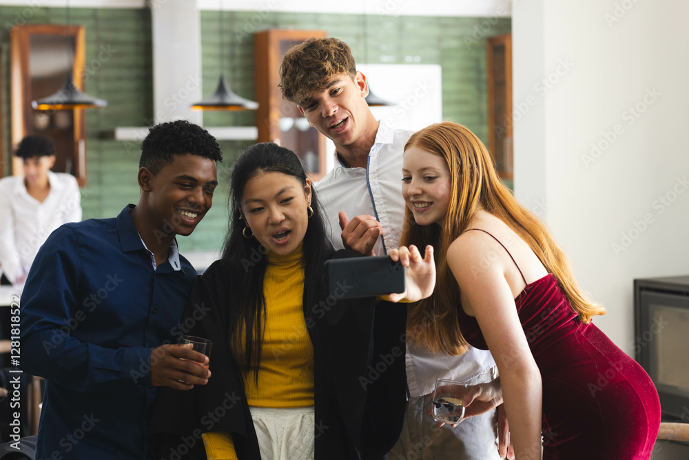Obraz premium Teen diverse friends laughing and taking selfie together at home during celebration