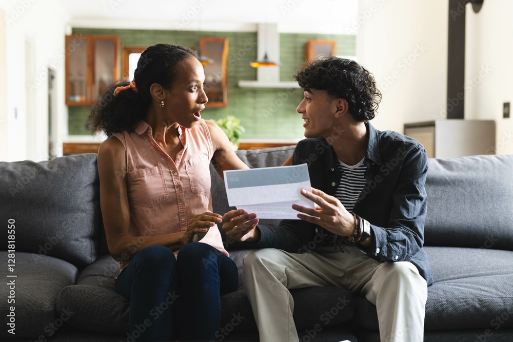 Φωτογραφία Celebrating success, teen showing acceptance letter to woman on living room couc