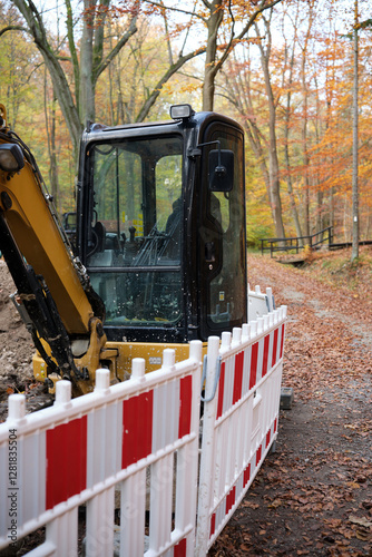 Obraz na płótnie A Compact Loader in a Beautiful Autumn Forest Landscape Perfect for Construction Work w salonie
