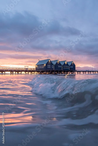 Busselton jetty with wave in foreground at sunset