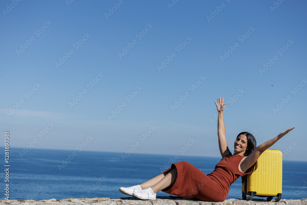 Young woman celebrating the beginning of her vacation with her yellow suitcase, recently arrived at the place of her trip, days of fun, happiness, heat, beach, tourism await her... Young woman celebrating the beginning of her vacation with her yellow suitcase, recently arrived at the place of her trip, days of fun, happiness, heat, beach, tourism await her...
