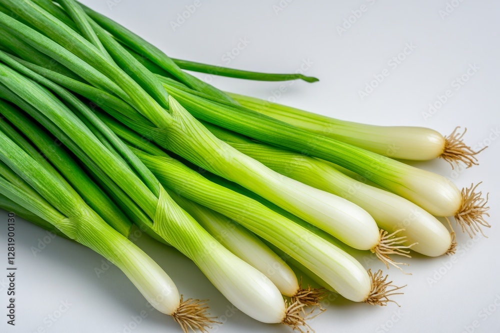 Fresh green onions laid out on a white surface ready for culinary use in salads and garnishes for various dishes Fresh green onions laid out on a white surface ready for culinary use in salads and garnishes for various dishes