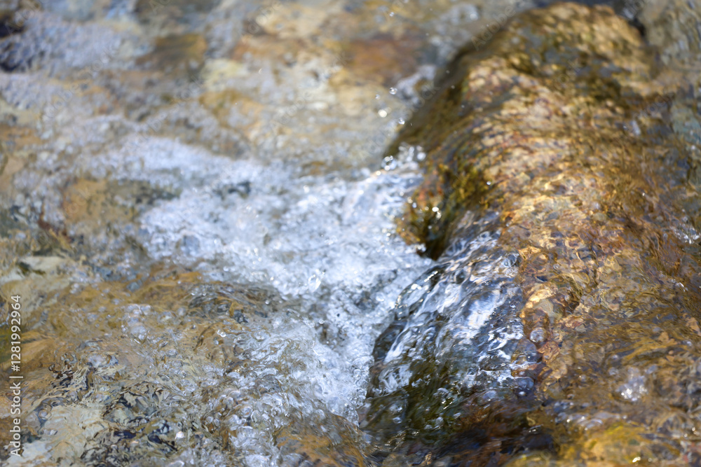 Close-Up of Clear Mountain Stream Flowing Over Natural Rocks Close-Up of Clear Mountain Stream Flowing Over Natural Rocks