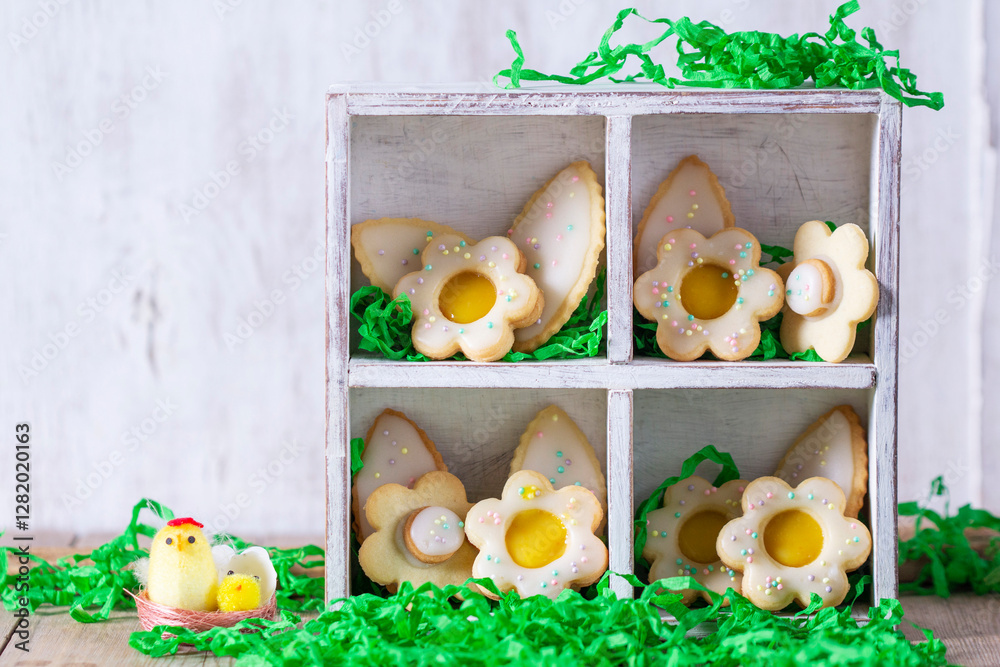 Shortbread cookies with lemon filling in the shape of butterflies, flowers and leaves.