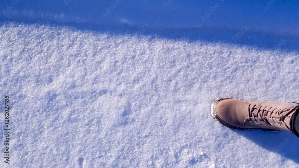 Women's winter boots leather with laces. A girl in winter shoes in the snow.