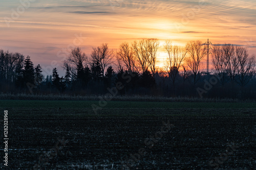 Coloful sunset over agriculture fields in winter at the Flemish countryside in Tienen, Belgium photo