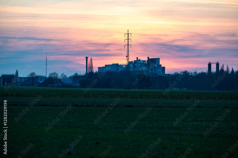 Harvested agriculture fields with a sugar refinery at the horizon, Tienen, Belgium Harvested agriculture fields with a sugar refinery at the horizon, Tienen, Belgium