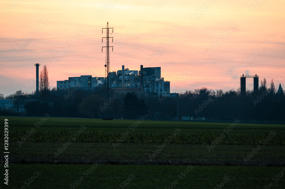 Harvested agriculture fields with a sugar refinery at the horizon, Tienen, Belgium Harvested agriculture fields with a sugar refinery at the horizon, Tienen, Belgium