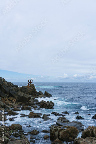 view of cantabria sea with waves on moody day in northern spain photo