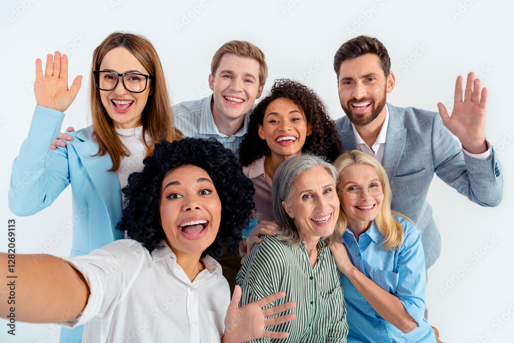 Smiling diverse group of professionals in office attire posing together on a gray background Smiling diverse group of professionals in office attire posing together on a gray background