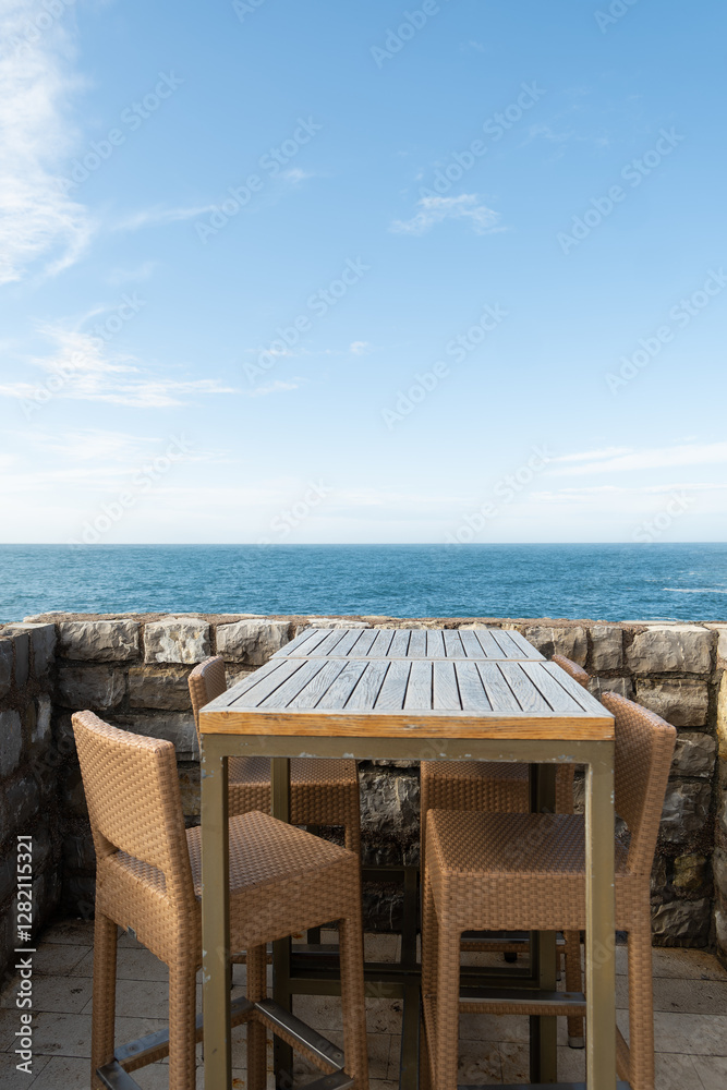 Fototapeta premium Fishing nets and sacks on a rusty cart by a Mediterranean Adriatic harbor, with mountains and sky