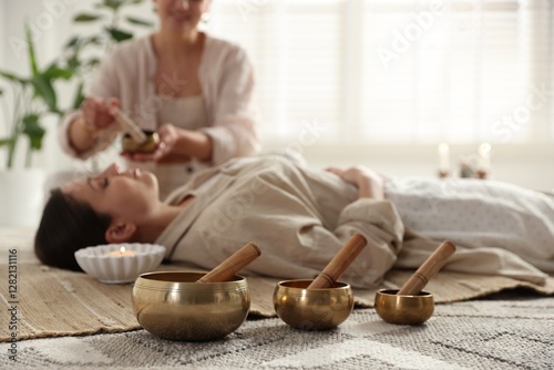 Obraz na płótnie Woman undergoing singing bowl therapy indoors, selective focus