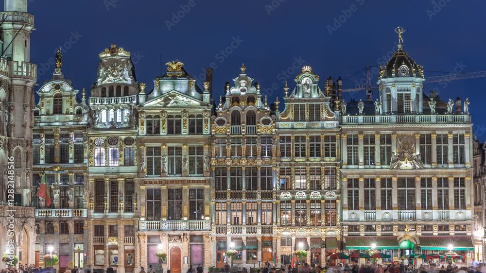 Illuminated Grand Place Guilds facade day to night transition timelapse in Brussels, Belgium. Historic art guild associations in Baroque architecture, with people walking on the UNESCO-listed square