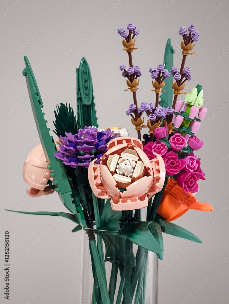 Naklejka premium Prague, Czech republic - February 20, 2025: Colorful lego flower bouquet in glass vase, celebrating creativity and playfulness
