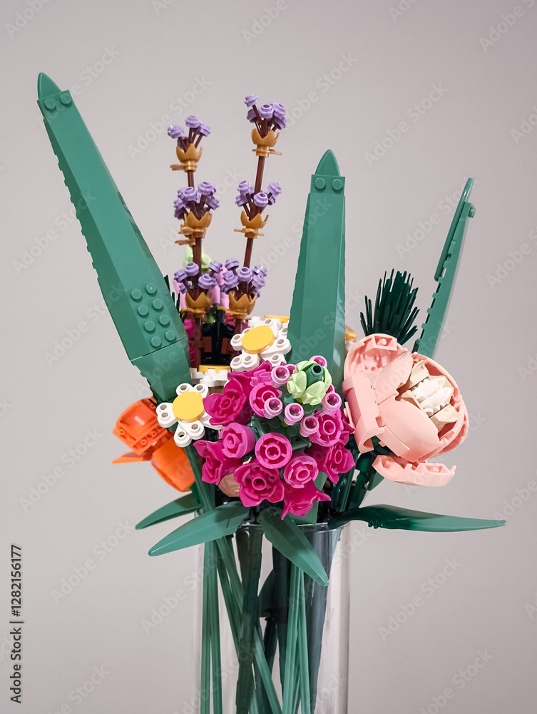 Naklejka premium Prague, Czech republic - February 20, 2025: Colorful lego flower bouquet in glass vase