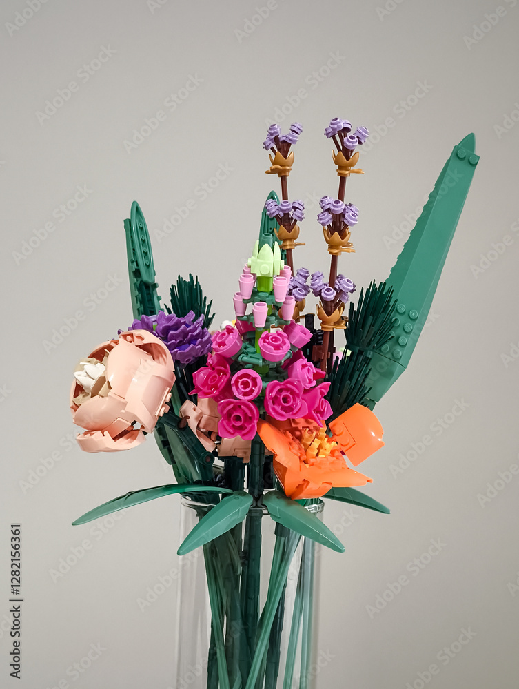 Naklejka premium Prague, Czech republic - February 20, 2025: Colorful lego flower bouquet in glass vase