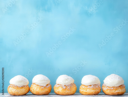 Fresh Donuts with Cream Topping on a Blue Background