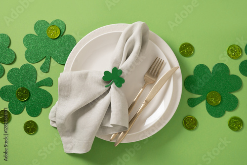 Obraz na płótnie St Patrick's Day table setting with white plate and traditional decoration, shamrock, clover leaves and coins on green background. View from above. Banner. w salonie
