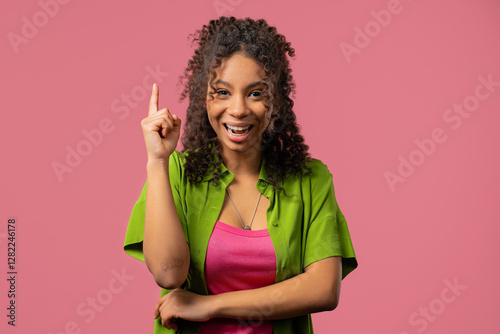 Genius creative idea, african teenager girl - eureka moment, pointing finger up
