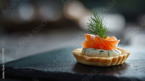 Fine dining amuse-bouche - miniature tartlet with smoked salmon and dill