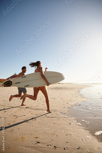 Photography Surfing, couple and running on beach with blue sky, waves and summer bonding together in ocean