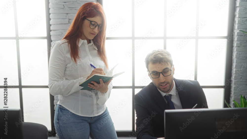 Business partners collaborate in an office with a woman taking notes while a man works on the computer, reflecting teamwork and productivity in a professional setting. Business partners collaborate in an office with a woman taking notes while a man works on the computer, reflecting teamwork and productivity in a professional setting.
