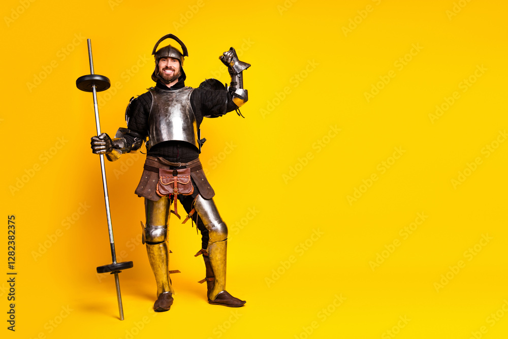 Man in medieval knight armor posing with a barbell on a vibrant yellow background Man in medieval knight armor posing with a barbell on a vibrant yellow background