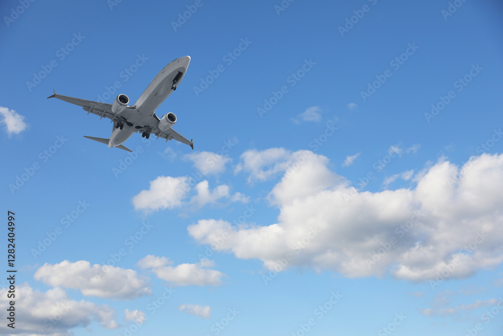 Airplane flying in beautiful blue sky with clouds Airplane flying in beautiful blue sky with clouds