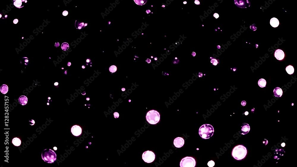 Abstract video with a top-down angle capturing floating purple bubbles against a black background, creating a dreamy, cosmic atmosphere.
