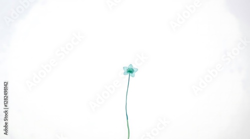 A minimalist watercolor painting of a simple flower, utilizing a limited palette of soft blues and greens, characterized by delicate brushstrokes and soft edges.