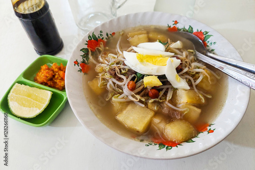 Indonesian Food Upi soup with chili sauce, soy sauce and orange on the table