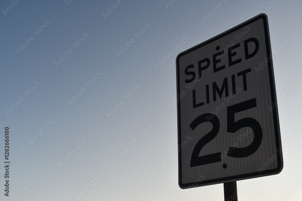 Speed limit 25 sign. Twilight sun from behind. Speed limit 25 sign. Twilight sun from behind.