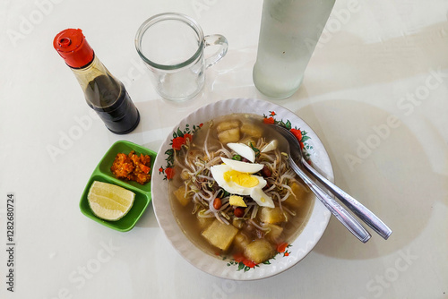 Indonesian Food Upi soup with chili sauce, soy sauce and orange on the table