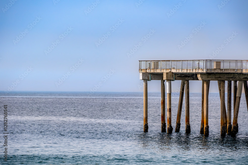 Open seascape photo with partial of Hermosa Beach Pier with blue sky and no people Open seascape photo with partial of Hermosa Beach Pier with blue sky and no people