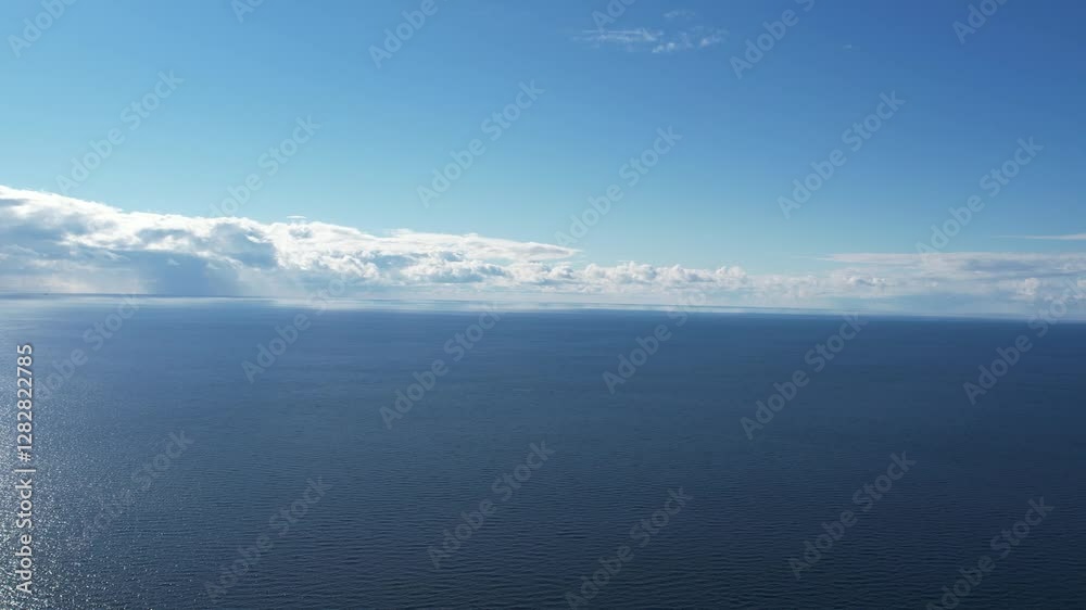 Calm Ocean Scene Under Clear Blue Sky and Bright Sunlight