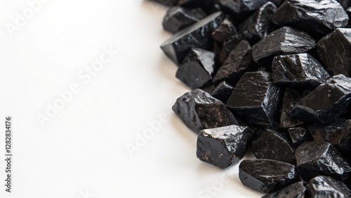 Polished Black Obsidian Stones on White Background Natural Healing Crystals photo