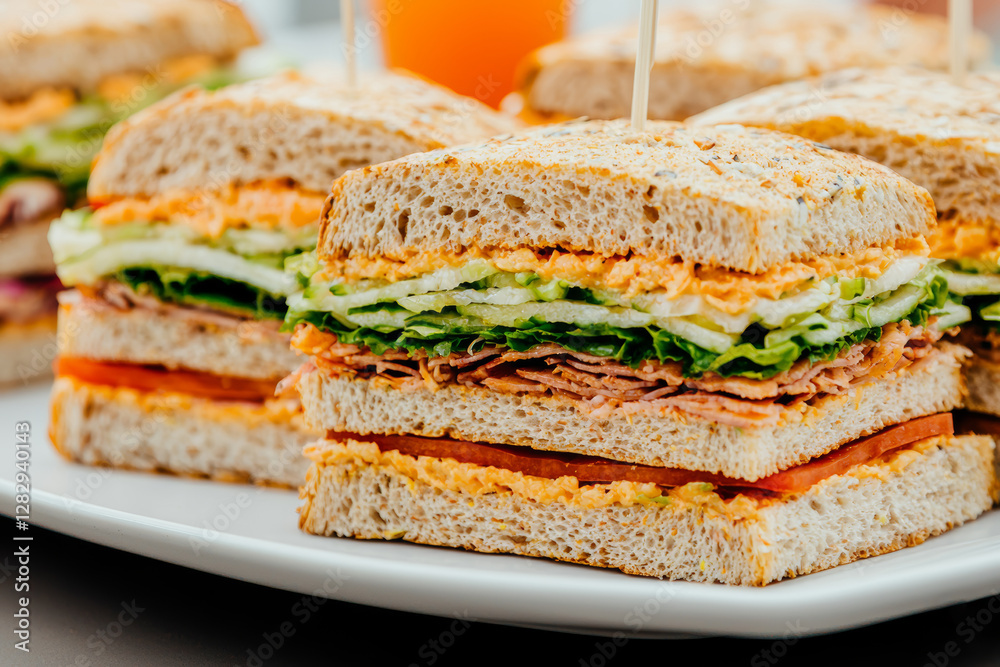 Delicious sandwiches and drinks neatly arranged on platter, ready to enjoy Delicious sandwiches and drinks neatly arranged on platter, ready to enjoy