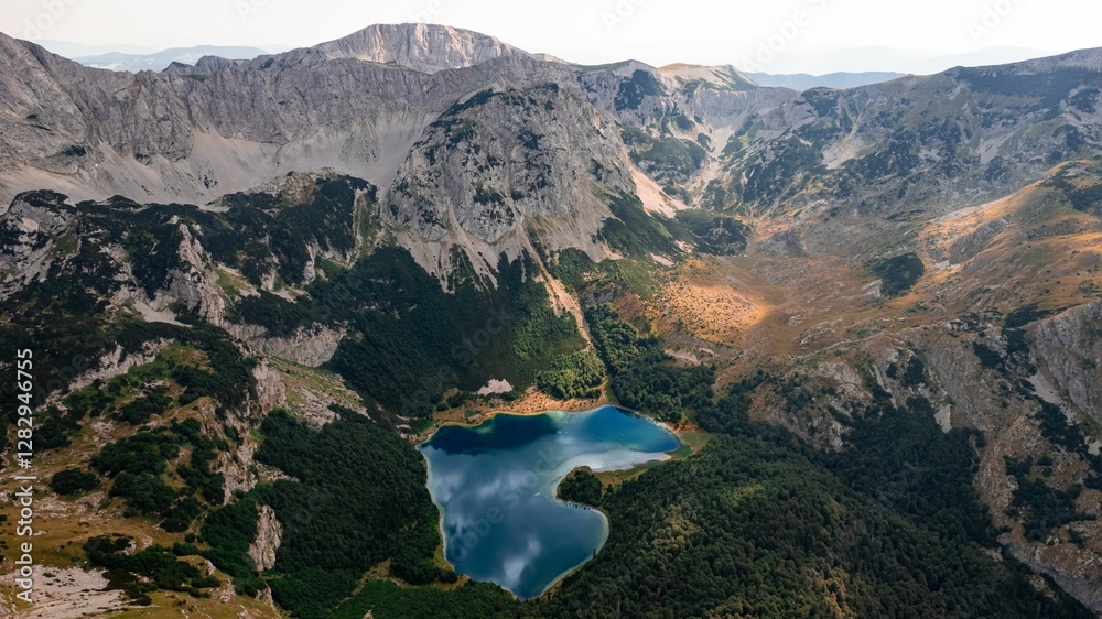 Fototapeta premium Aerial view of mountain lake and peaks