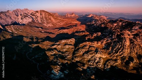 Aerial view of a mountain range at sunset.