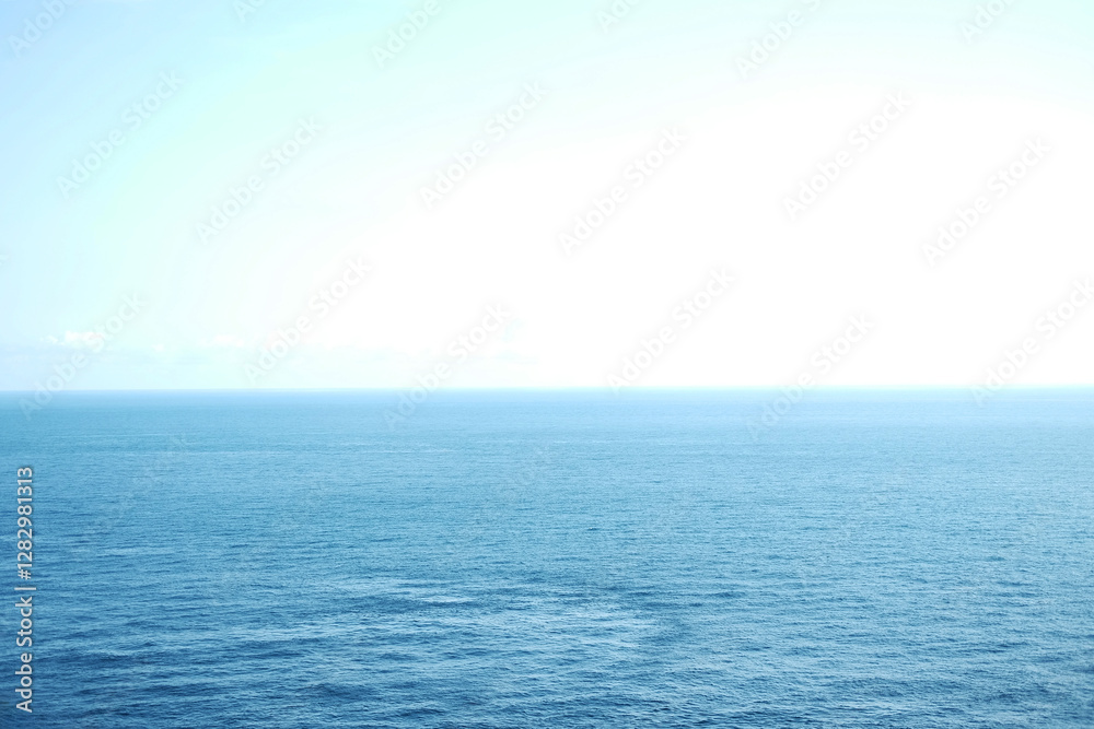 landscape of horizontal calm blue sea with wave and cloud and blue sky in bright day. Vacation and travel destination summer of ocean in Bali, Indonesia landscape of horizontal calm blue sea with wave and cloud and blue sky in bright day. Vacation and travel destination summer of ocean in Bali, Indonesia