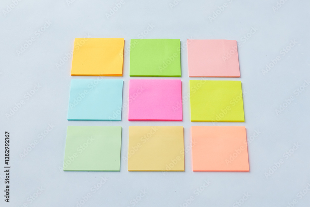 Colorful Sticky Notes Arranged in a Grid Pattern on a Light Background for Organizational Purposes Colorful Sticky Notes Arranged in a Grid Pattern on a Light Background for Organizational Purposes