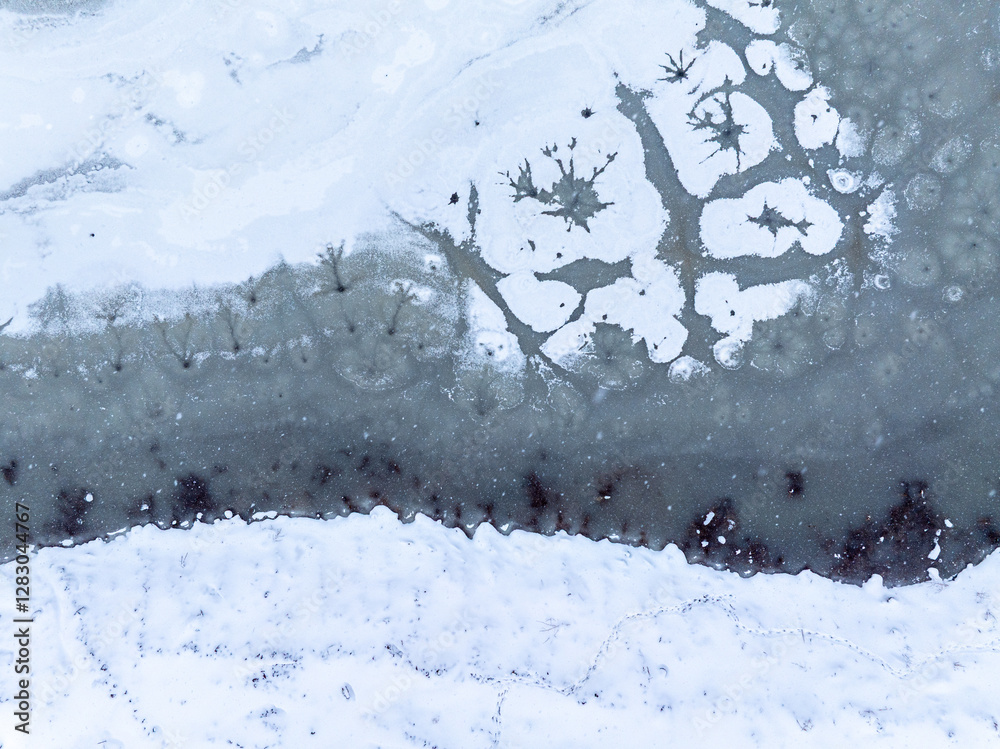 Winter abstract frozen textures. Aerial view of a frozen lake with intricate ice formations, showing unique patterns and natural beauty in a winter landscape.