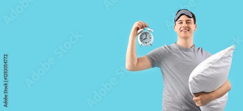 Happy young man holding ala...