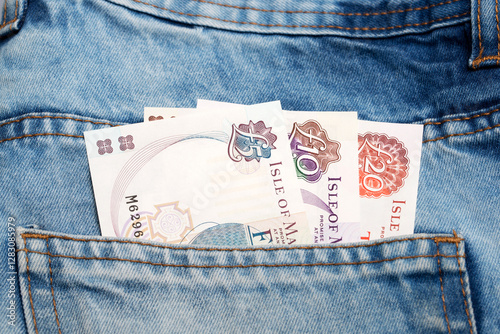 Manx pound  in the pocket of blue jeans